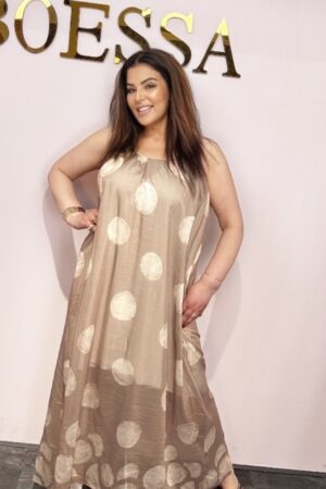Beige oversized maxi jurk met stippen voor dames Luchtige beige zomerjurk met stippenprint Trendy beige maxi jurk met verstelbare spaghettibandjes Oversized beige jurk met comfortabele onderjurk Lange beige jurk met stippen dames