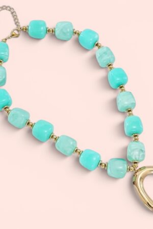 Statement kralenketting in turquoise en geel met gouden hanger