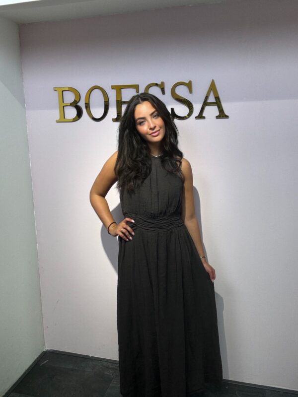 Stijlvolle chocolade bruine maxidress met halterhals en plooidetails in de taille. Comfortabel, elegant en geschikt voor maat 36 tot 44. Shop jouw zomerlook bij Boessa Mode!
